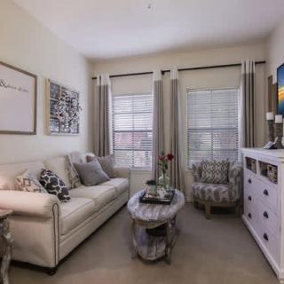 A cozy living room with a sofa, armchair, and stylish decor.