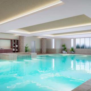 A modern indoor swimming pool with a luxurious design.