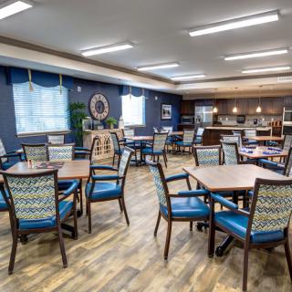 A modern dining area with tables and chairs, featuring a spacious and well-lit interior.