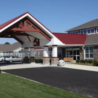 A suburban building with a covered entrance and a driveway.