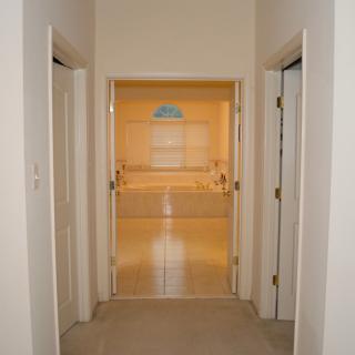 View of a hallway with doors leading to different rooms.