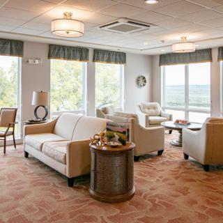A bright and relaxing lounge area with comfortable seating and large windows.