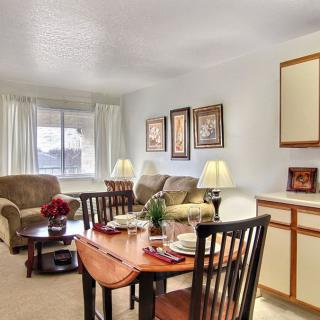 Cozy and well-lit living and dining space with comfortable seating and elegant decor.