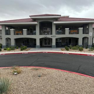 A two-story hotel building with a landscaped entrance.