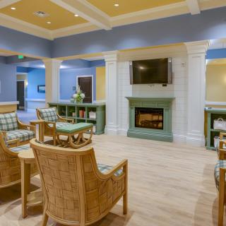 A cozy living room with a fireplace and television, featuring comfortable seating and modern decor.