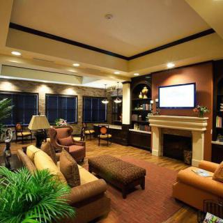 A cozy and modern living room with comfortable seating, a television, and a fireplace.