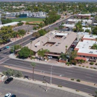 An aerial view of an intersection in a city with buildings and roads.