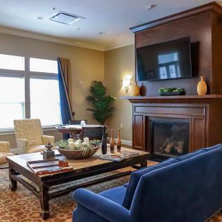 A cozy living room features a fireplace and elegant seating arrangement.