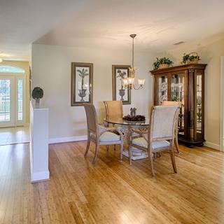 A cozy dining area with a wooden table and chairs, complemented by elegant d�cor and a chandelier.