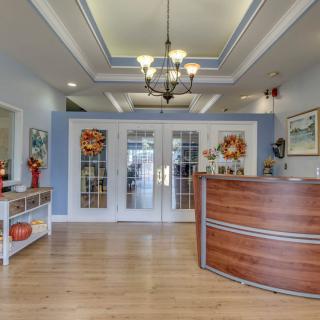 A welcoming office reception area with a wooden desk and decorative elements.