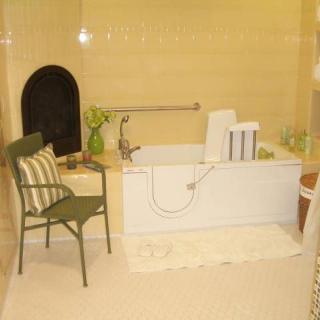 A modern bathroom features a bathtub with a decorative chair and towels arranged neatly.