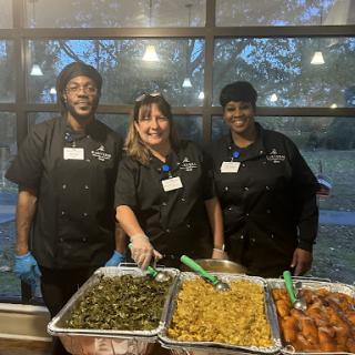 Dedicated volunteers serving delicious dishes at a community event.