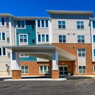 A modern residential apartment building with a covered entrance.