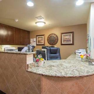 A welcoming reception area with a granite-topped desk and decorative elements.