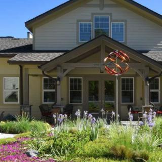 A charming residential house with a beautifully landscaped garden in the front yard.