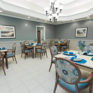 A well-appointed dining room with elegant decor and neatly arranged tables and chairs.