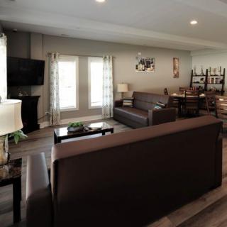 A cozy and well-decorated living room with modern furniture and a dining area.