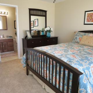 A cozy and stylish bedroom with a comfortable bed, decorative bedding, and a touch of elegance.