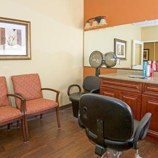 An interior view of a hair salon with chairs and a styling station.