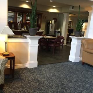 A cozy lobby area with seating and plants.