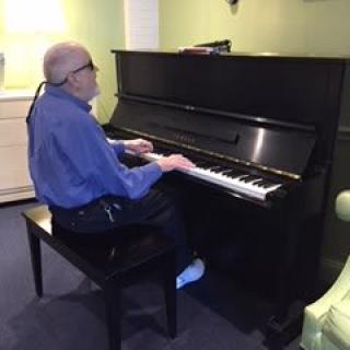 A person playing the piano indoors.