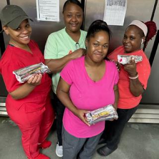 A dedicated team proudly showcasing their culinary creations.