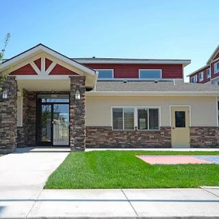 A modern residential house featuring a stone facade and well-maintained front yard.