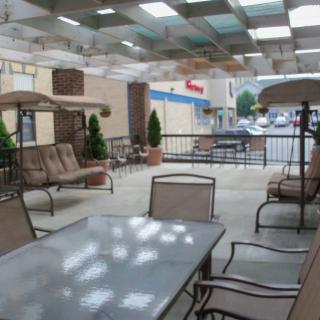 A covered outdoor patio with tables and seating for relaxation.