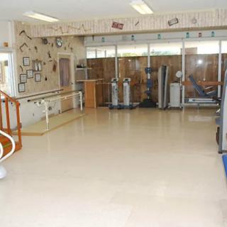 A fitness room equipped with exercise machines for rehabilitation.