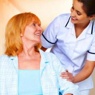 A nurse providing assistance to a patient, both smiling.