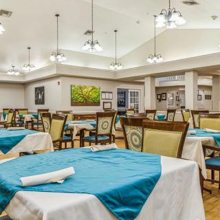 A spacious dining room with neatly arranged tables and elegant lighting.