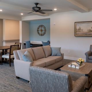 A modern living room with a cozy seating arrangement and adjoining dining area.