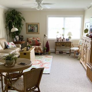 A cozy and bright living room with comfortable furniture and decorative elements.