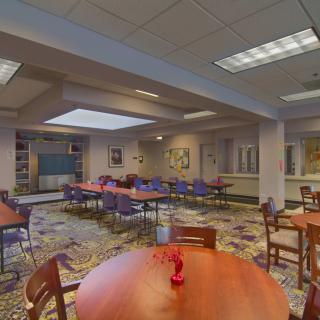 A spacious indoor dining area with multiple tables and chairs arranged for seating.