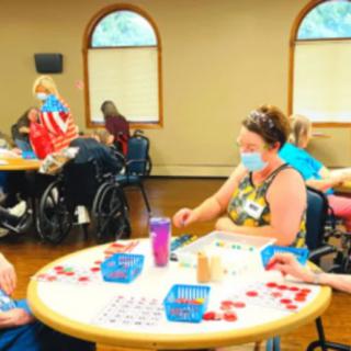 A group of people enjoying a game of bingo in a community center.