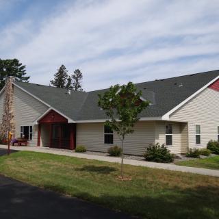 A suburban residential building with a landscaped front yard.