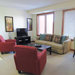 A cozy living room setup featuring comfortable seating and a television.