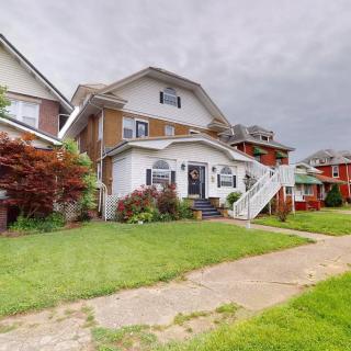 A suburban house with a well-maintained lawn on a cloudy day.