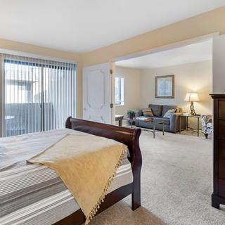 A cozy bedroom with elegant furnishings and abundant natural light.