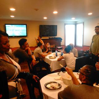 A lively gathering of friends enjoying a meal and conversation together.