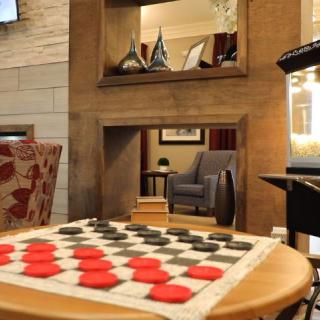 A cozy lounge area featuring a checkers game setup on a table.