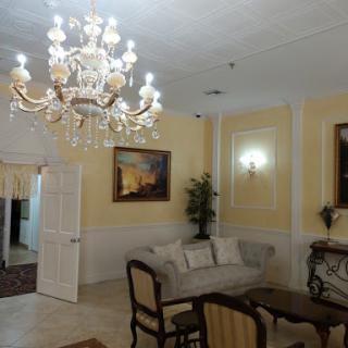 A beautifully decorated living room featuring a luxurious chandelier and elegant furniture.