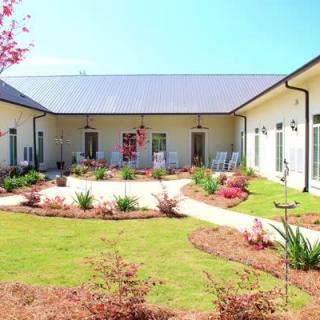 A well-maintained courtyard with landscaped gardens surrounded by a modern building.