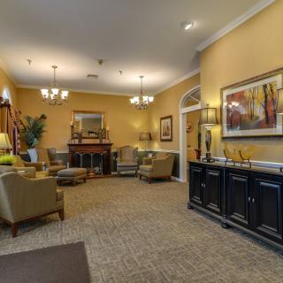A cozy living room with elegant furniture and warm lighting.