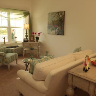 Cozy living room with elegant furniture and ample natural light.