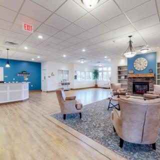 A cozy lobby with comfortable seating and a fireplace.