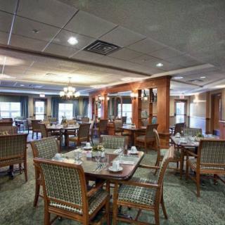 A well-arranged dining room with tables and chairs set for guests.