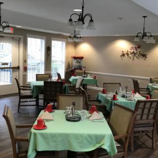 A cozy dining room with neatly arranged tables and chairs.
