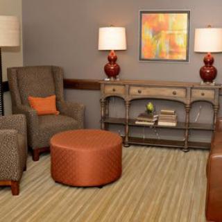 A cozy living room with comfortable seating and warm lighting.