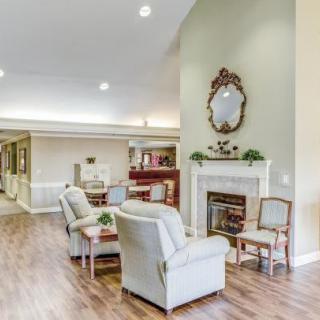 A cozy living room with comfortable seating, a fireplace, and elegant decor.